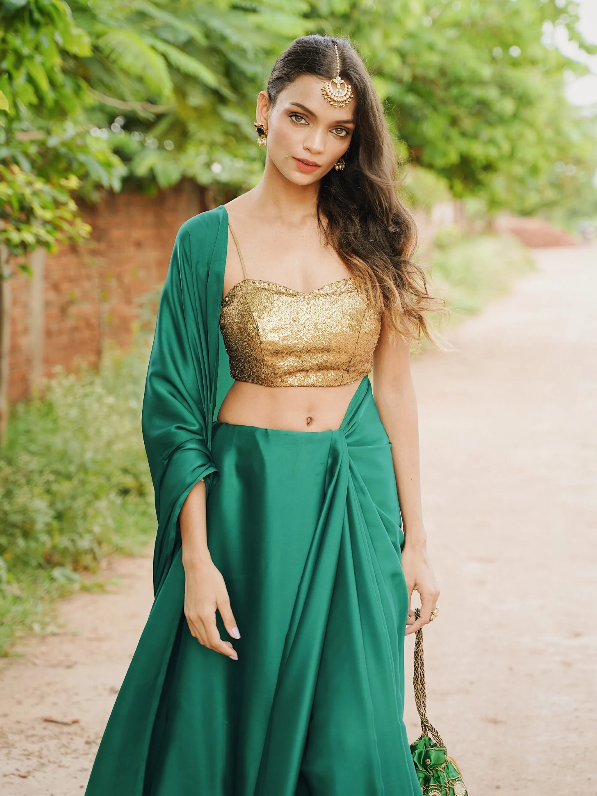 Rich Emerald Green Satin Saree with Bronze Pendants